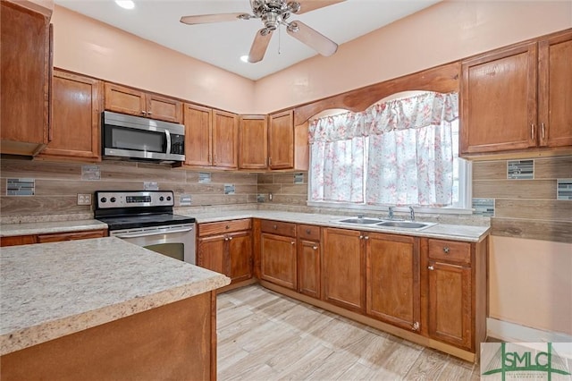 kitchen featuring ceiling fan, sink, stainless steel appliances, and tasteful backsplash