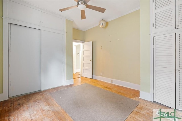 unfurnished bedroom featuring ceiling fan, light hardwood / wood-style flooring, and crown molding