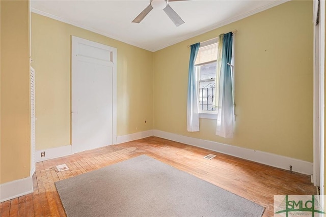 empty room featuring hardwood / wood-style flooring and ceiling fan