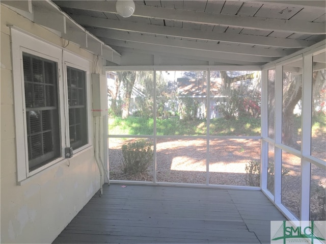 unfurnished sunroom featuring wood ceiling and lofted ceiling with beams