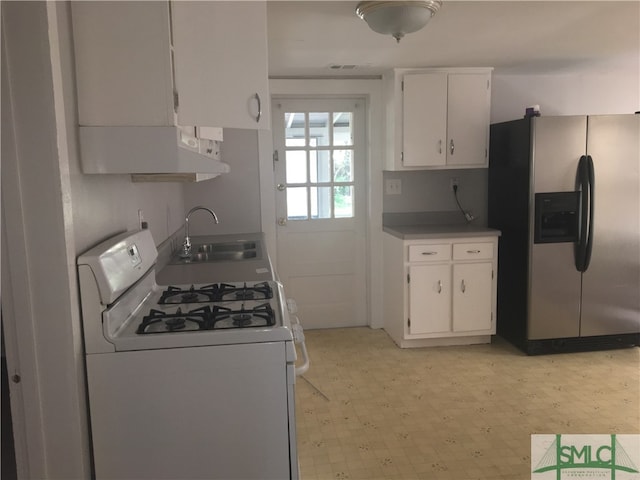 kitchen with sink, white cabinets, stainless steel refrigerator with ice dispenser, and white gas range oven