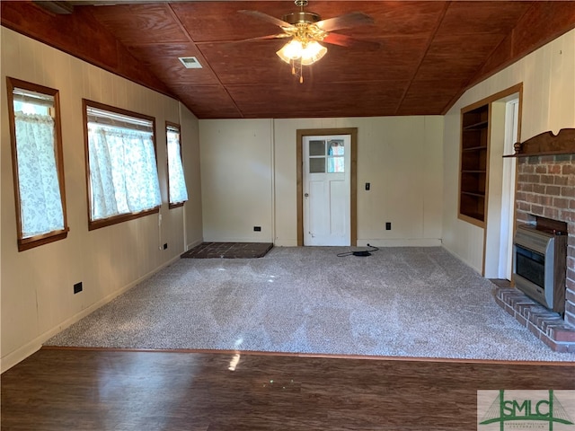 unfurnished living room with a fireplace, lofted ceiling, carpet floors, and wood ceiling