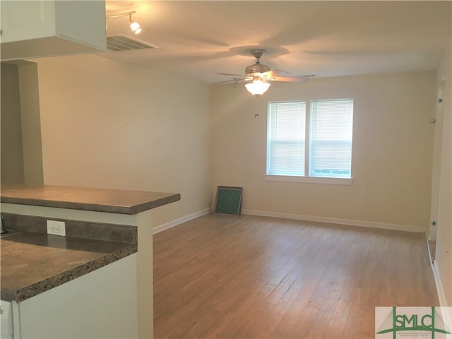 unfurnished living room with ceiling fan and light hardwood / wood-style floors