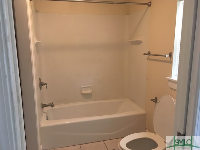 bathroom featuring tile patterned flooring, shower / bathtub combination, and toilet