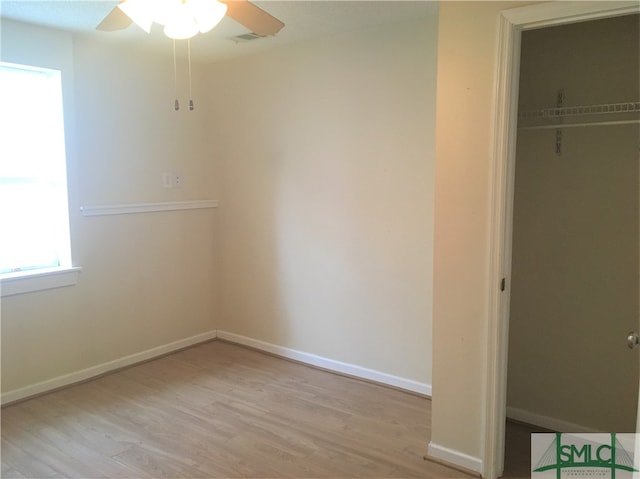 unfurnished bedroom with ceiling fan, a closet, and light wood-type flooring