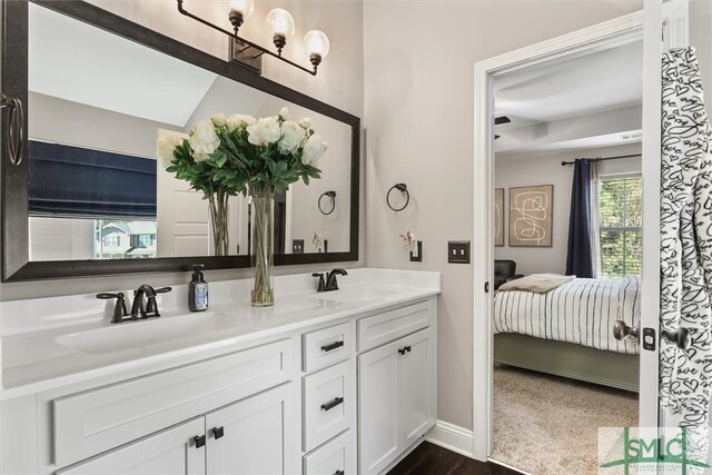 bathroom featuring vanity and lofted ceiling