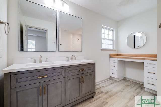 bathroom with vanity, a textured ceiling, and hardwood / wood-style flooring