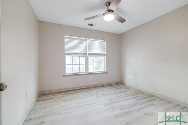 empty room featuring ceiling fan, a textured ceiling, and light hardwood / wood-style flooring