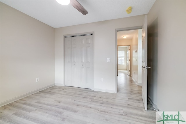 unfurnished bedroom with a closet, ceiling fan, a textured ceiling, and light hardwood / wood-style floors