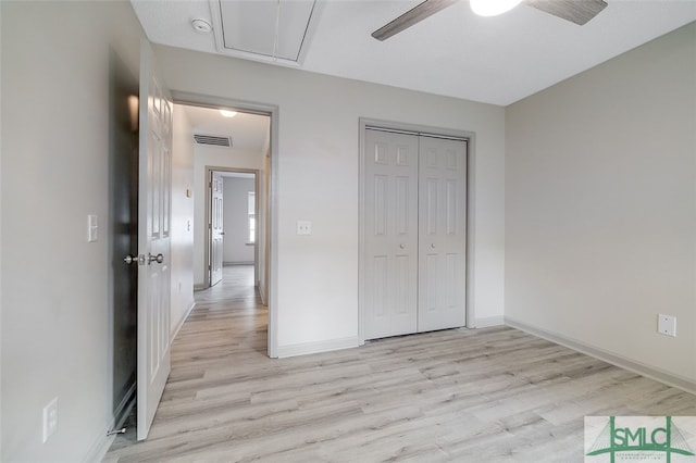 unfurnished bedroom with light hardwood / wood-style floors, a closet, and ceiling fan