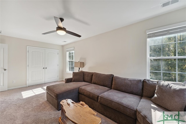 living room featuring carpet and ceiling fan