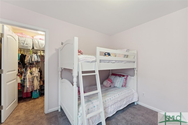 bedroom featuring a spacious closet, carpet, and a closet