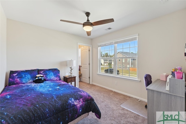 bedroom with ceiling fan and light carpet