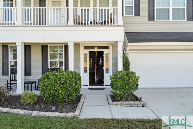 property entrance featuring a balcony and a garage