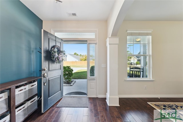 foyer featuring decorative columns and dark hardwood / wood-style flooring