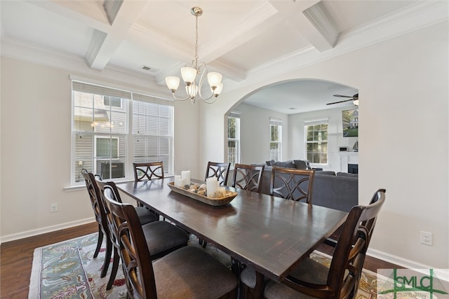 dining area with crown molding, ceiling fan with notable chandelier, dark hardwood / wood-style flooring, coffered ceiling, and beam ceiling