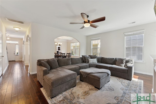 living room with ceiling fan and dark hardwood / wood-style floors