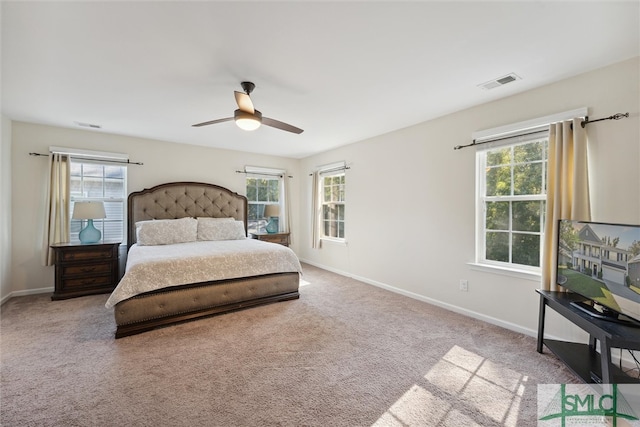 bedroom with ceiling fan, multiple windows, and carpet floors