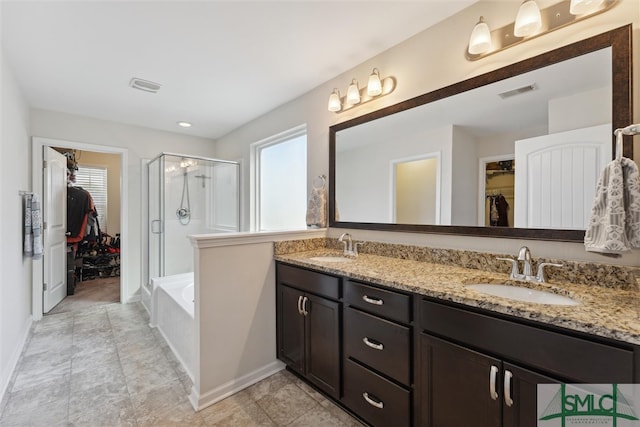 bathroom with vanity, independent shower and bath, and a wealth of natural light