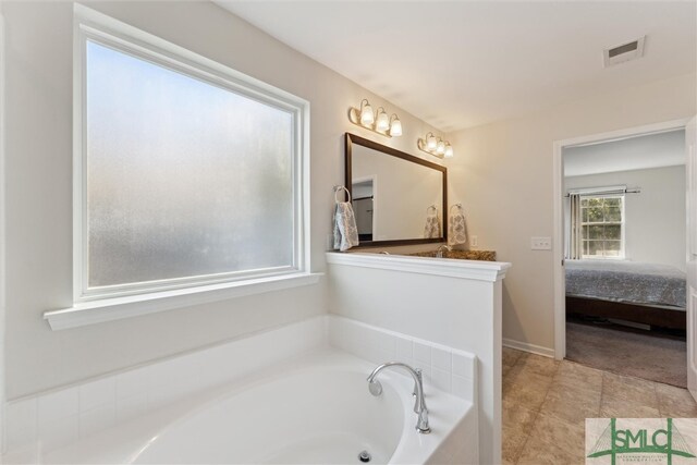 bathroom featuring a tub and tile patterned floors