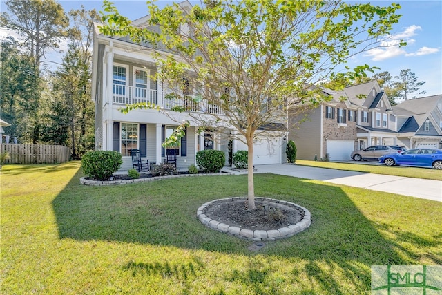 view of front of home with a front yard, a garage, and a balcony