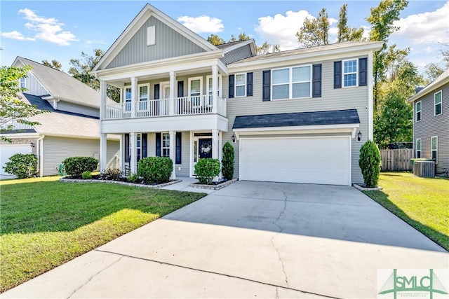 view of front of house featuring a front lawn, a garage, and a balcony