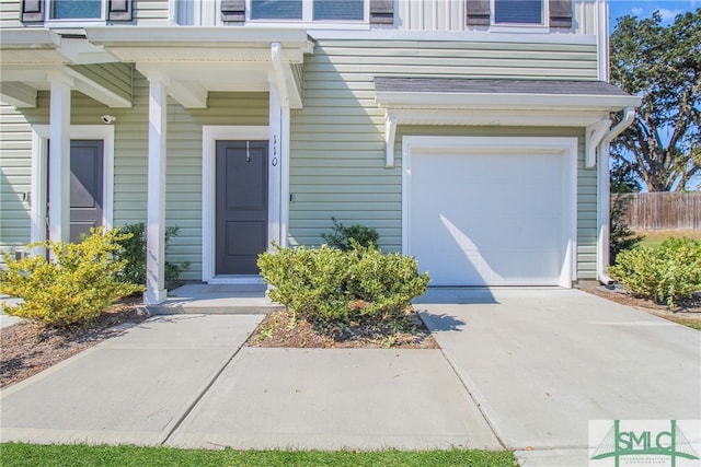 entrance to property with covered porch and a garage