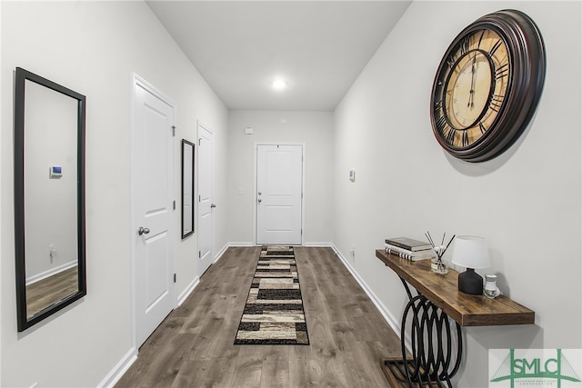 hall with hardwood / wood-style floors