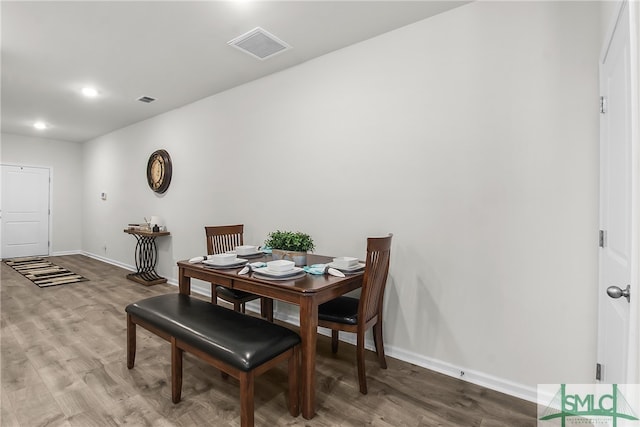 dining space with hardwood / wood-style floors