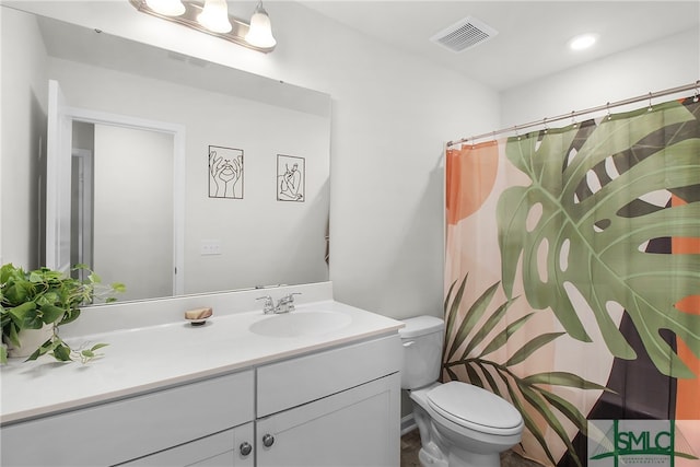 bathroom featuring vanity, toilet, and walk in shower