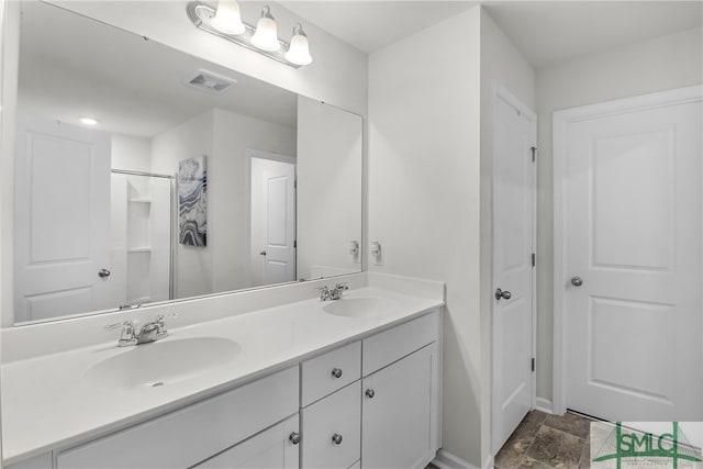 bathroom with vanity and a shower