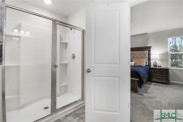 bathroom featuring a shower with door