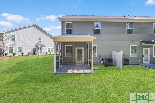 rear view of house with a patio, a yard, and central AC unit