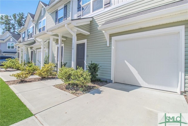 110 Benelli Dr, Pooler, GA 31322 - doorway to property featuring an attached garage and concrete driveway
