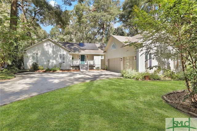 view of front facade with a garage, a front lawn, and solar panels