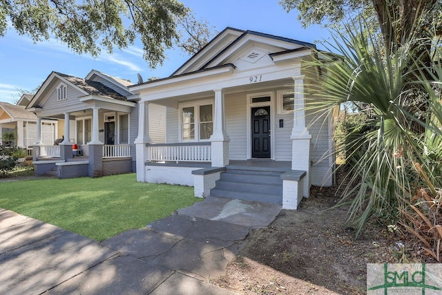 bungalow-style home with a front yard and a porch