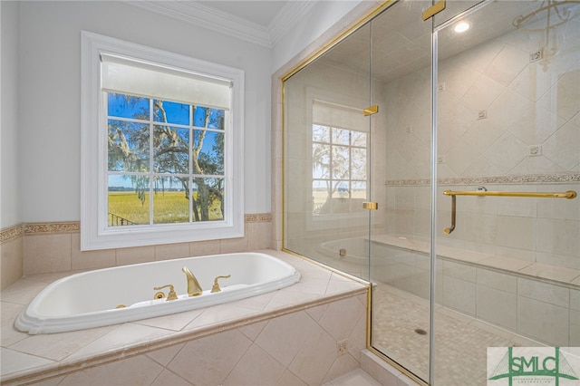 bathroom with independent shower and bath, ornamental molding, and a healthy amount of sunlight