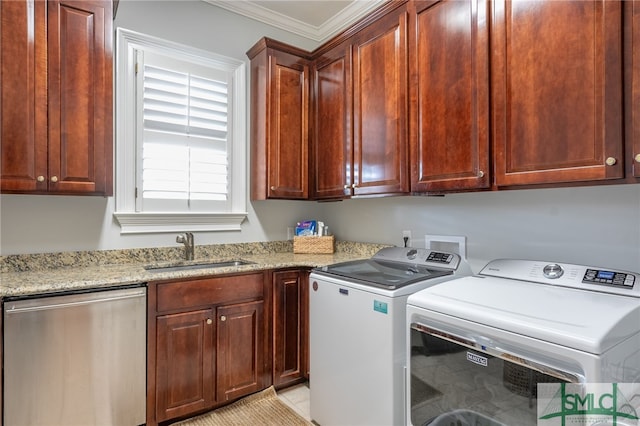 laundry area with cabinets, ornamental molding, light tile patterned flooring, sink, and washer and clothes dryer