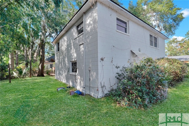 view of side of property with a lawn