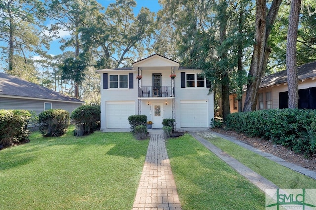 view of front of home with a balcony, a front lawn, and a garage