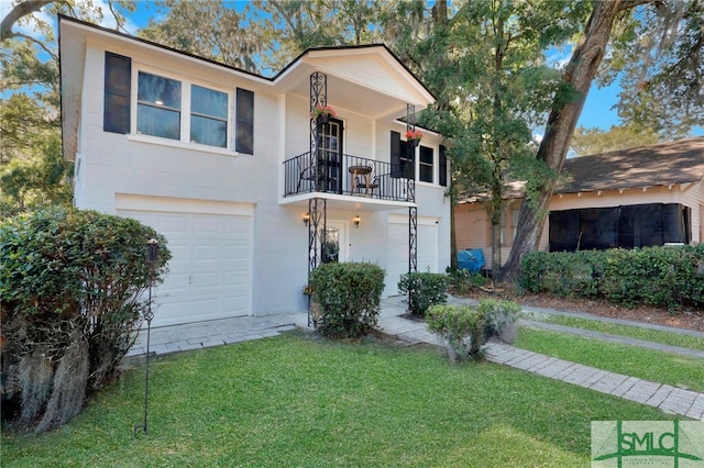 view of front of home featuring a balcony, a garage, and a front lawn