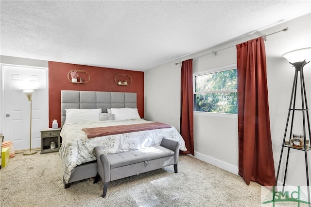 bedroom featuring light carpet and a textured ceiling