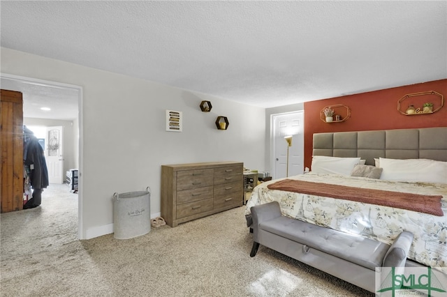 carpeted bedroom featuring a textured ceiling