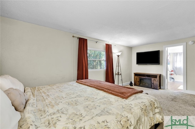 bedroom with carpet floors and a textured ceiling