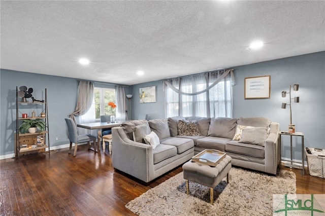 living room with dark hardwood / wood-style floors and a textured ceiling