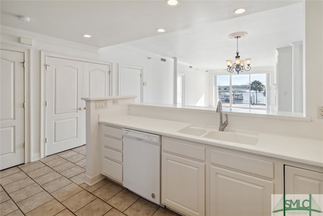 kitchen featuring hanging light fixtures, an inviting chandelier, white cabinetry, white dishwasher, and sink