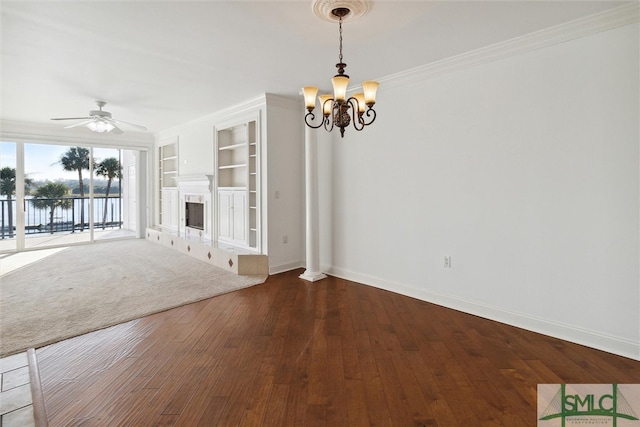 unfurnished living room featuring ornamental molding, hardwood / wood-style floors, ceiling fan with notable chandelier, and built in features