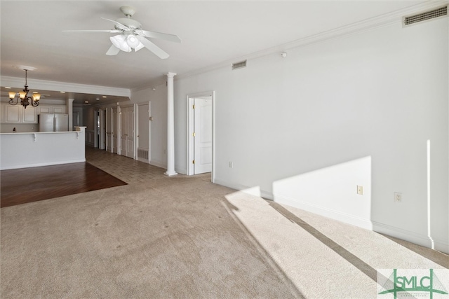 unfurnished living room featuring ornamental molding, light carpet, and ornate columns