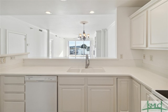 kitchen featuring hanging light fixtures, sink, a notable chandelier, white cabinets, and white appliances