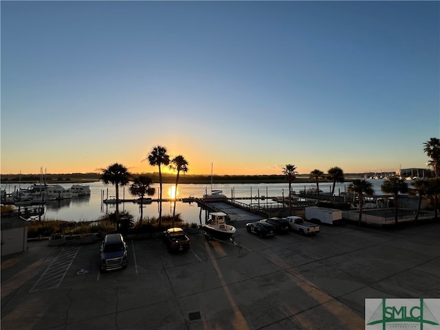 exterior space featuring a dock and a water view